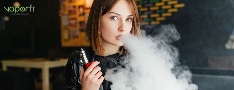 woman with red mod blowing e-juice cloud